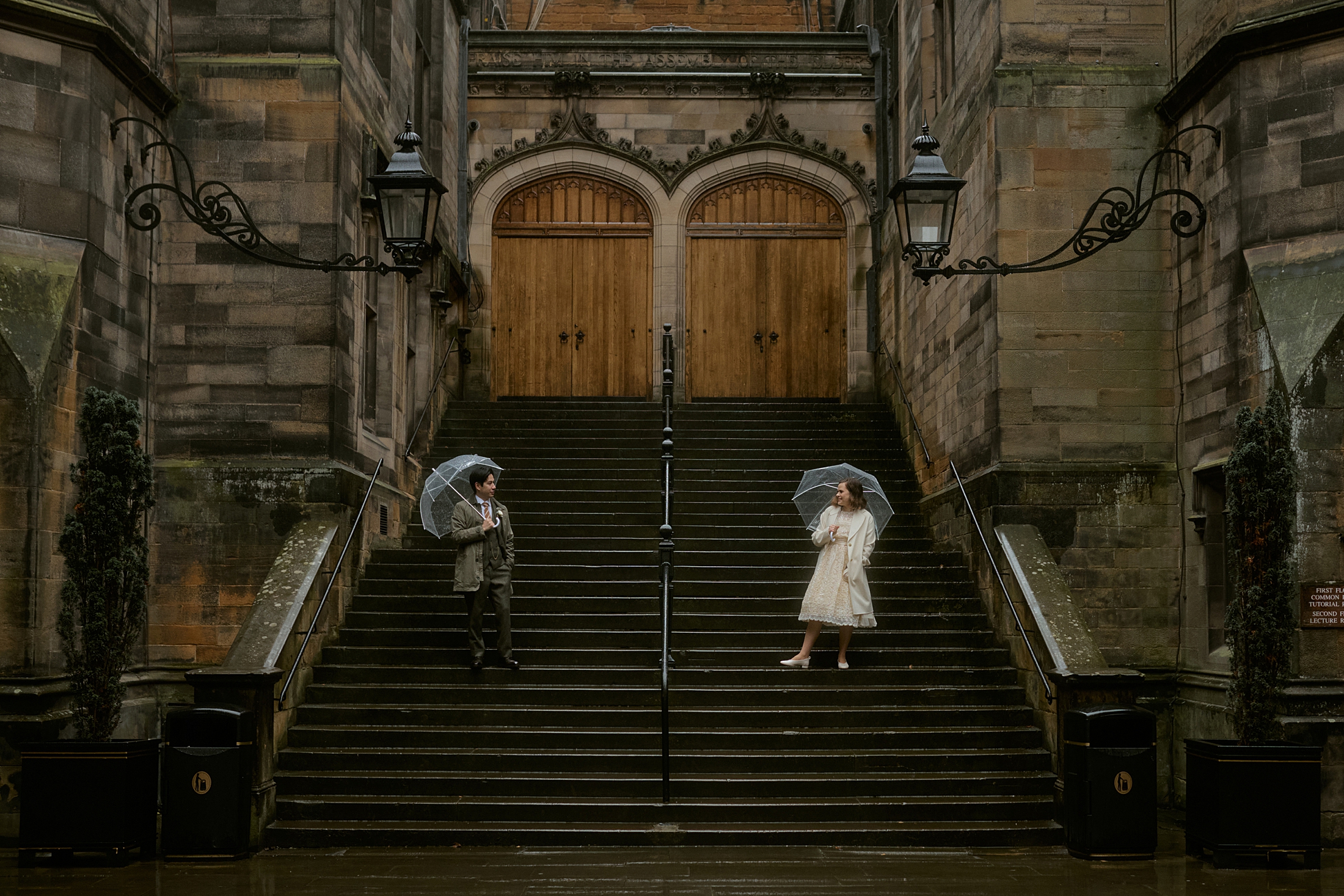 Couple on steps at New College courtyard in Edinburgh during elopement photographed by Edinburgh elopement photographer