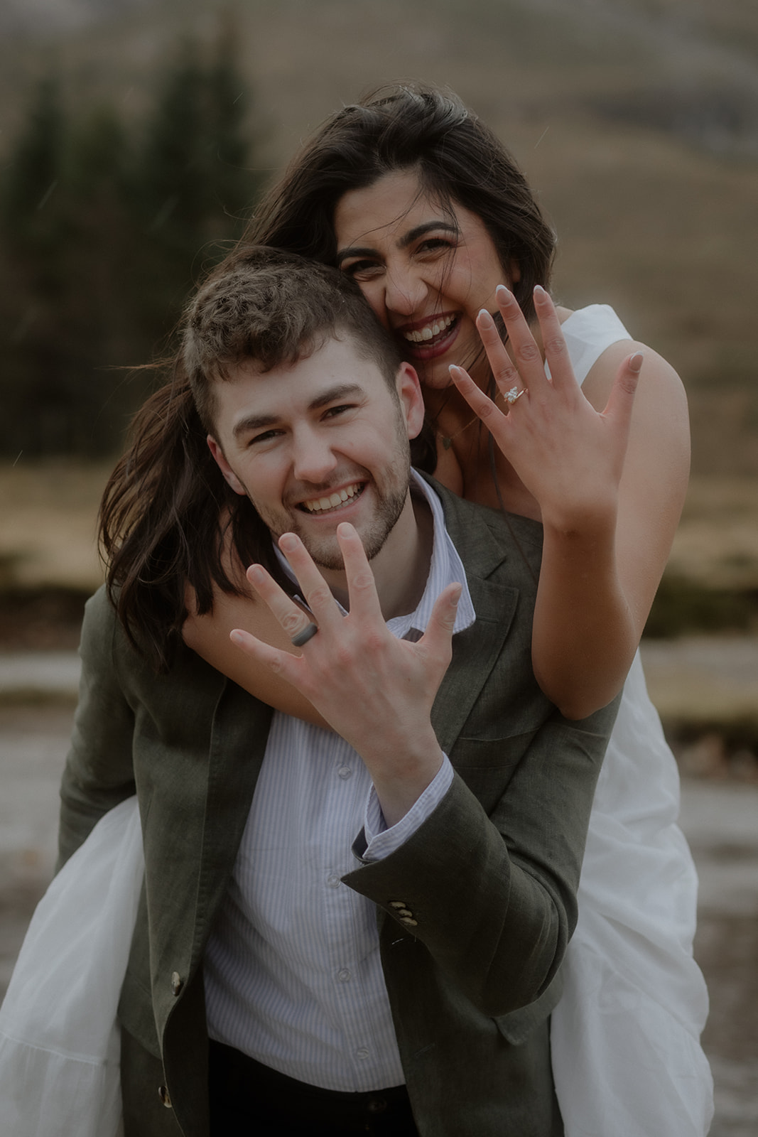 Couple showing engagement ring after surprise proposal in Glencoe Scotland
