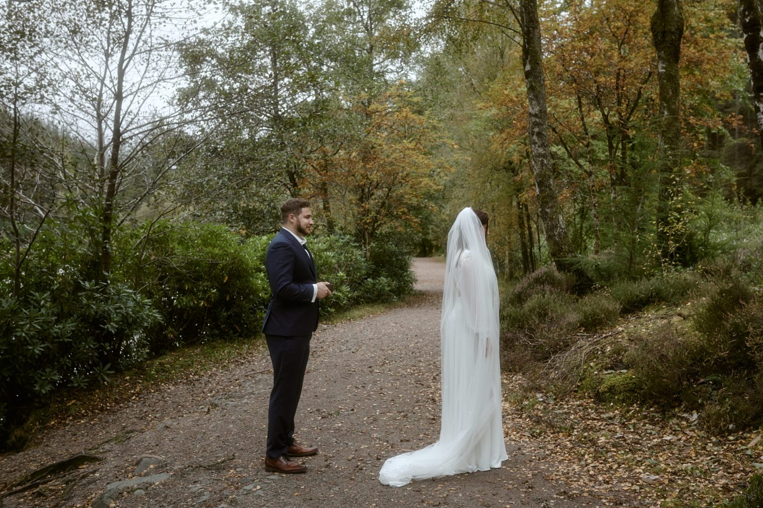 Bride and groom first look during Glencoe Lochan elopement in Scottish Highlands