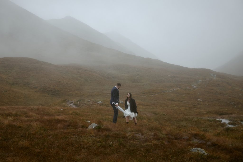 Couple in misty Glencoe Highlands during private vow exchange Scotland