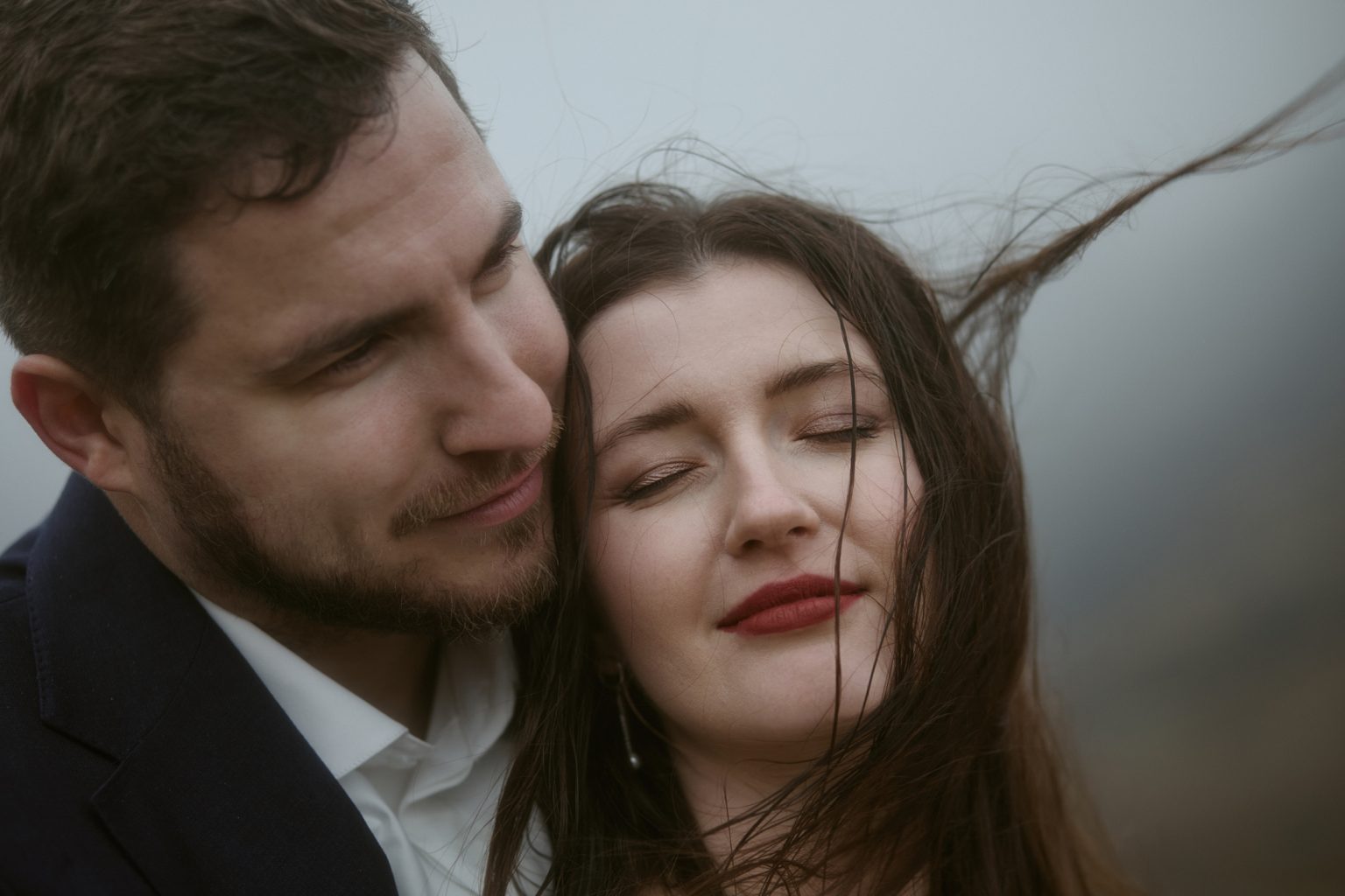Close-up couple portrait in wind during Scotland elopement in the Highlands